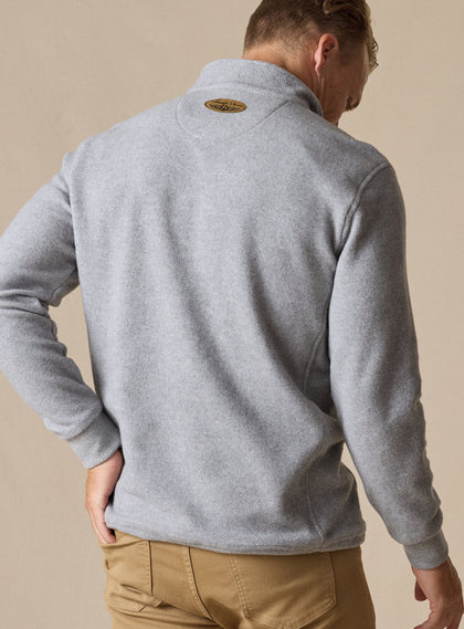  Men's Leucadia Quarter Snap Pullover in Light Charcoal, back view on model featuring a heather gray fleece long sleeve pullover with brand patch at the neckline