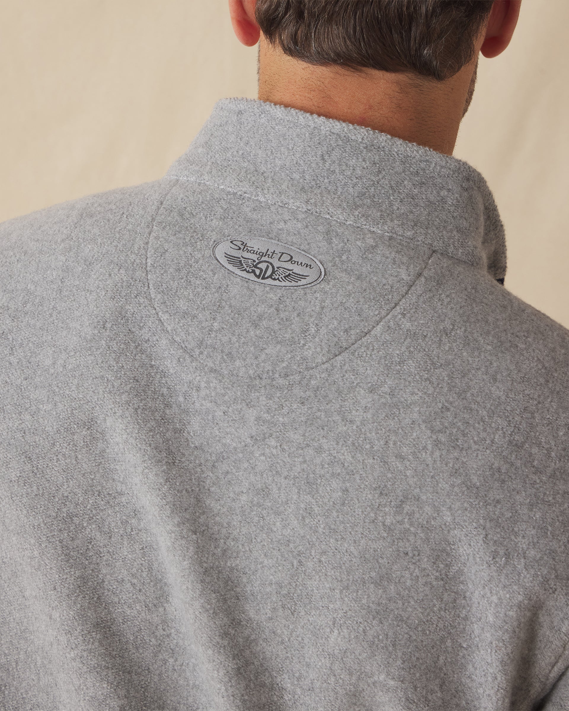 Men's Leucadia Quarter Snap Pullover in Heather, close-up back view on model highlighting the Straight Down logo detail at the upper back