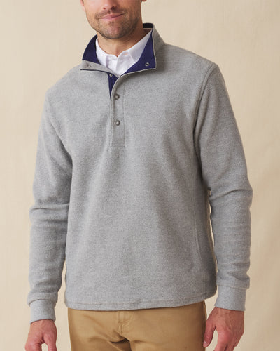 Men's Leucadia Quarter Snap Pullover in Heather, front view on model featuring a heather gray fleece with navy contrast inner collar and snap closure neckline, paired with tan pants