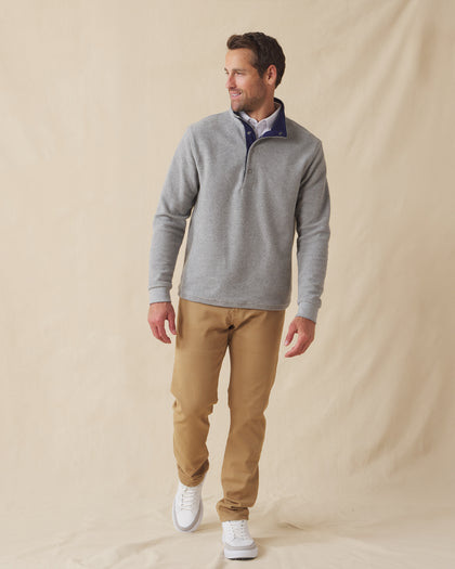 Men's Leucadia Quarter Snap Pullover in Heather, full length front view on model featuring a heather gray fleece with navy contrast inner collar, paired with tan pants and white shoes
