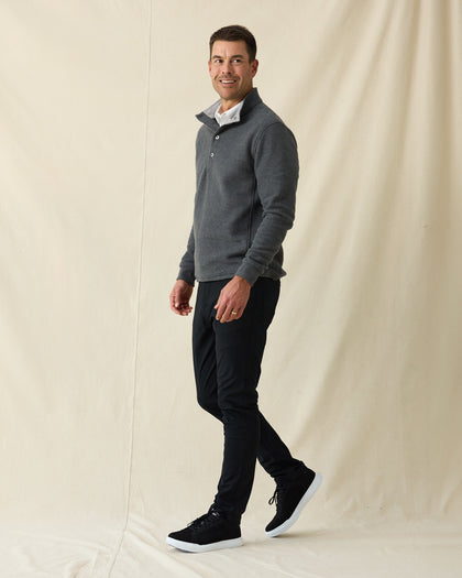 Men's Leucadia Quarter Snap Pullover in Charcoal, full length side view on model featuring a charcoal heather fleece with snap closure neckline, paired with black pants and black shoes