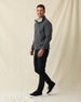 Men's Leucadia Quarter Snap Pullover in Charcoal, full length side view on model featuring a charcoal heather fleece with snap closure neckline, paired with black pants and black shoes