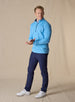Men's Patron Quarter Zip in Niagara, full-length front view in solid light blue, paired with navy pants and white golf shoes