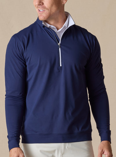 Mens Patron Quarter Zip in new indigo dark blue, front view on model styled with white polo