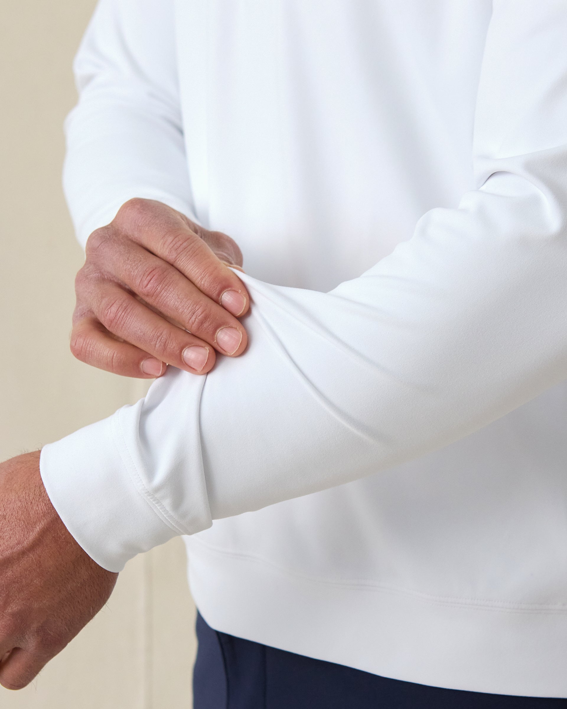 Men's Patron Quarter Zip in White Sage, close-up sleeve view on model highlighting the stretch fabric and ribbed cuff detail on a white base