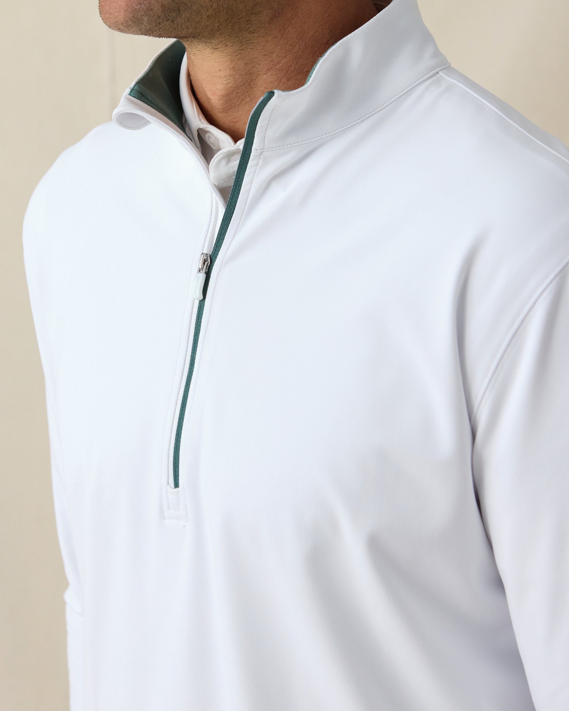 Men's Patron Quarter Zip in White Sage, close-up front view on model highlighting the sage contrast zipper and collar lining detail on a white base