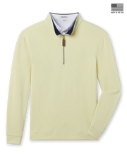 Men’s pale yellow quarter-zip pullover with ribbed texture, navy contrast collar, and zip closure featuring a leather pull tab. Made in the USA.