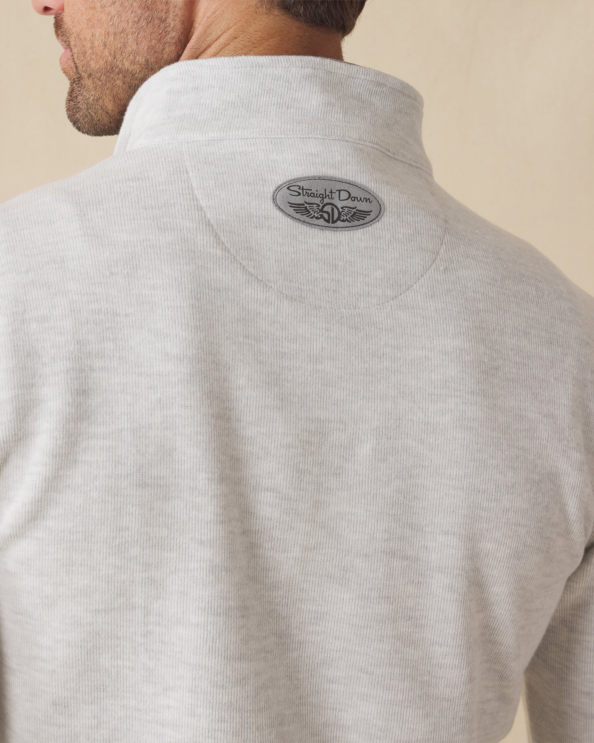 Men's Montecito Quarter Zip in Heather, close-up back view on model highlighting the Straight Down logo detail at the upper back