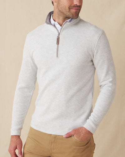 Men's Montecito Quarter Zip in Heather, front view on model featuring a light heather gray ribbed knit with silver quarter zip and leather zip pull, paired with tan pants