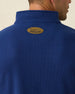 Men's Montecito Quarter Zip in New Indigo, close-up back neck view on model highlighting the tan oval Straight Down leather patch at center back neck and ribbed knit texture detail