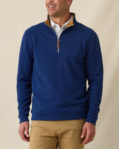 Men's Montecito Quarter Zip in New Indigo, front view on model featuring a ribbed knit texture with tan suede collar lining, silver zipper with leather pull tab, layered over a white polo, paired with khaki pants