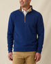 Men's Montecito Quarter Zip in New Indigo, front view on model featuring a ribbed knit texture with tan suede collar lining, silver zipper with leather pull tab, layered over a white polo, paired with khaki pants