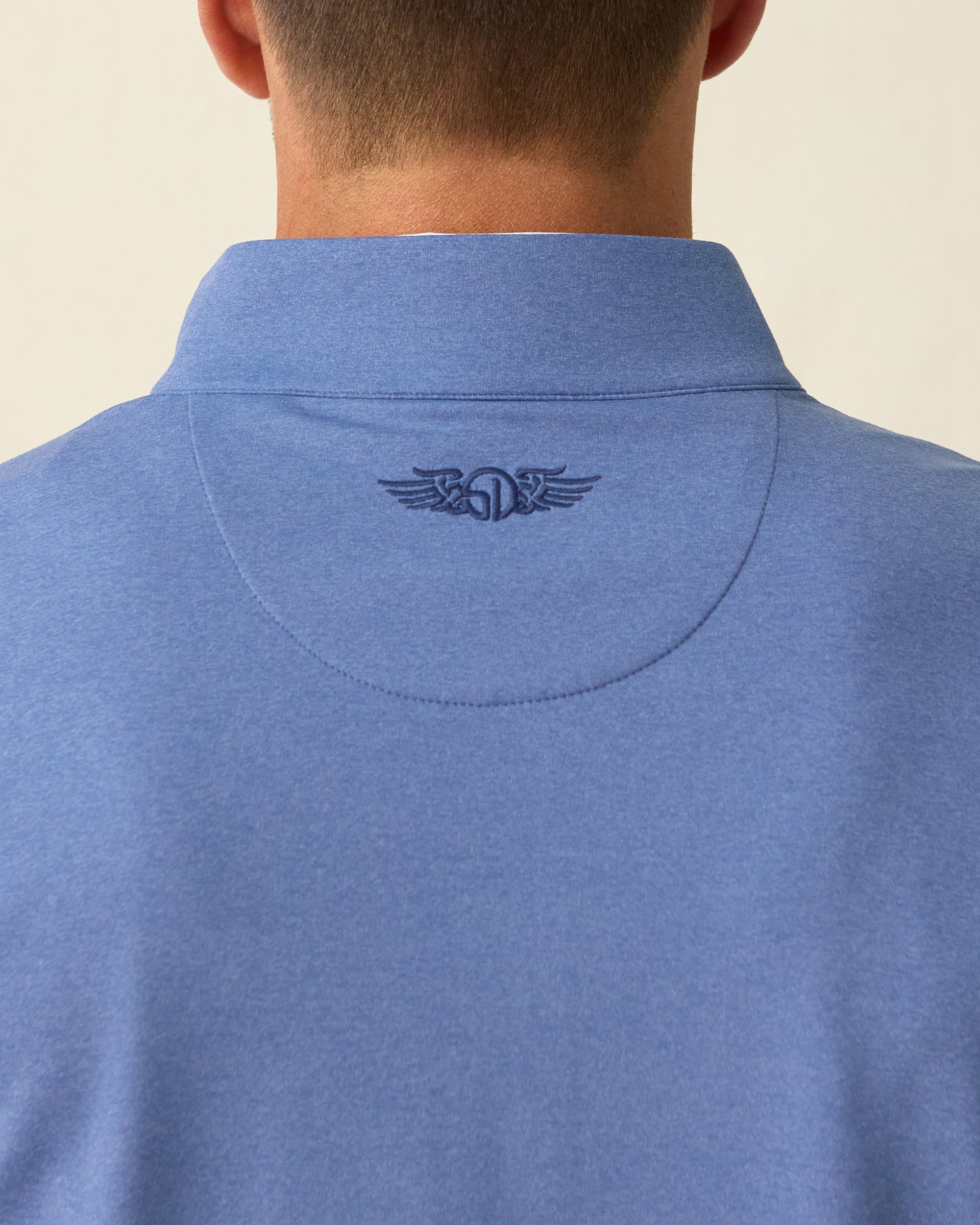 Men's Tiburon Quarter Zip in Moonlight, close-up back neck view on model highlighting the tonal Straight Down logo embroidered at center back neck