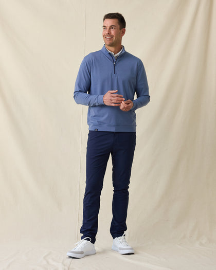 Men's Tiburon Quarter Zip in Moonlight, full length front view on model featuring a heathered jersey with navy quarter zip placket, layered over a white polo, paired with navy pants and white shoes