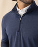 Men's Tiburon Quarter Zip in New Indigo, close-up front view highlighting the quarter zip neckline detail on the solid heathered navy body, layered over a white polo