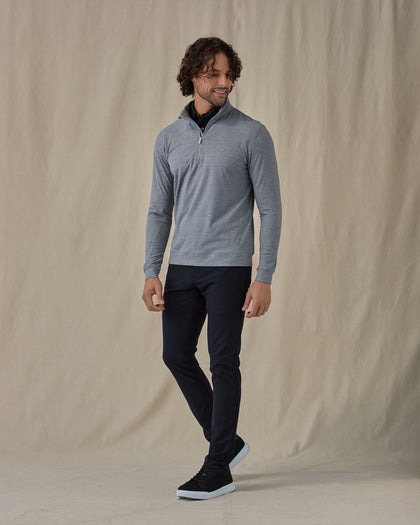Men's Tiburon Quarter Zip in Storm, full-length side view on model featuring a heathered gray solid fabric with a quarter zip placket, paired with black pants and black shoes