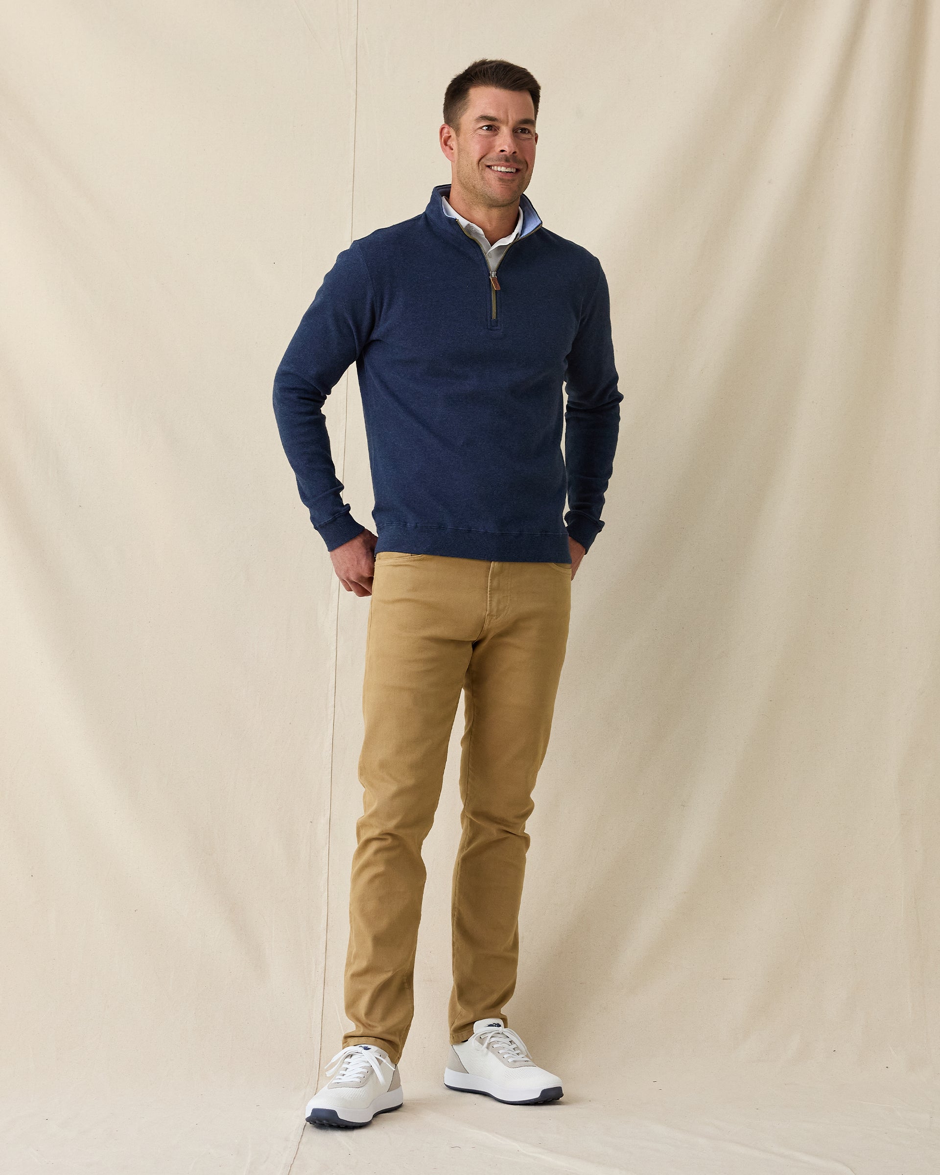 Men's Burnside 2.0 Quarter Zip in New Indigo, full length front view on model featuring a heathered fleece with light blue collar lining and brass zipper, layered over a white polo, paired with khaki pants and white shoes