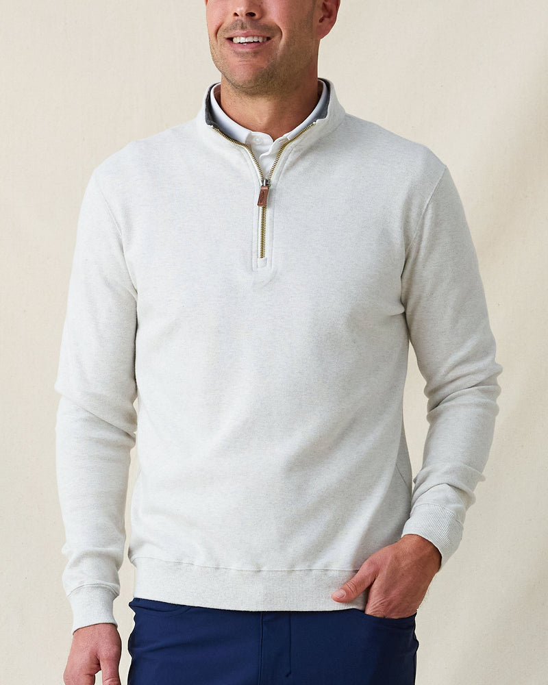 Men's Burnside 2.0 Quarter Zip in Heather, front view on model featuring a light heather gray fleece with brass quarter zip and leather zip pull, paired with navy pants