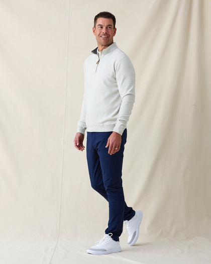 Men's Burnside 2.0 Quarter Zip in Heather, full length side view on model featuring a light heather gray fleece with brass quarter zip, paired with navy pants and white shoes