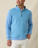 Men's Cardiff Quarter Zip in Coastal, front model view featuring a medium blue long sleeve quarter zip pullover with a textured waffle-knit front panel and navy contrast zip placket, layered over a white polo, styled with white pants