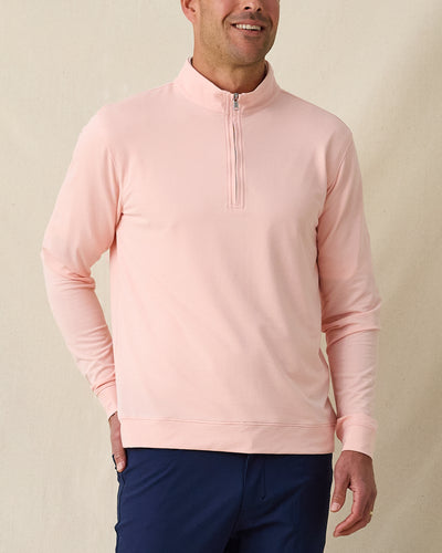 Men's Palmetto Quarter Zip in Spritz, front model view featuring a light pink long sleeve quarter zip pullover with a smooth performance fabric and silver zip hardware, layered over a white polo, styled with navy pants