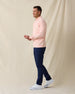 Men's Palmetto Quarter Zip in Spritz, side model view featuring a light pink long sleeve quarter zip pullover with a smooth performance fabric, styled with navy pants and white shoes
