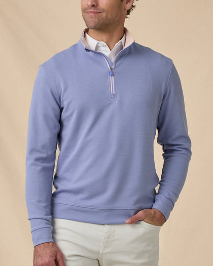 Man wearing the Warren Quarter Zip in Blue Shade over a white polo with silver pants.
