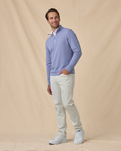Man wearing the Warren Quarter Zip in Blue Shade with silver pants and white golf shoes.