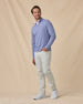 Man wearing the Warren Quarter Zip in Blue Shade with silver pants and white golf shoes.