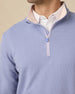 Close-up of the stand collar, blush trim and quarter-zip neckline.