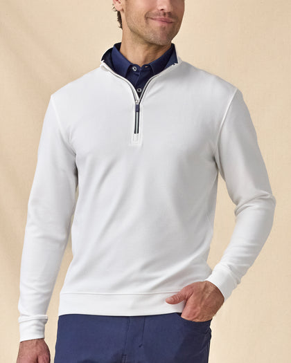 Model wearing the white Warren Quarter Zip layered over a navy polo with navy pants.