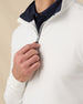 Close-up of the Warren Quarter Zip highlighting the textured white fabric, navy collar lining, and quarter-zip closure.
