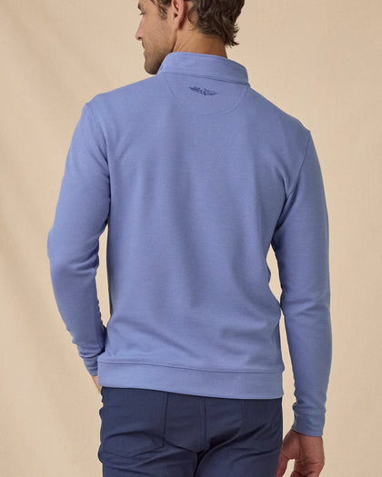 Men's Warren Quarter Zip in Tidal blue, back view styled with navy pants