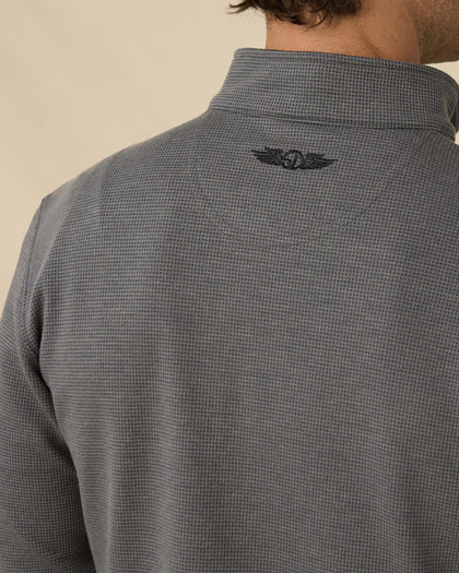 Close-up back view of the Warren Quarter Zip in Black showing the mini-grid textured knit and embroidered logo below the collar.