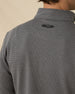 Close-up back view of the Warren Quarter Zip in Black showing the mini-grid textured knit and embroidered logo below the collar.