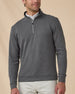 Model wearing the Warren Quarter Zip in Black layered over a white polo, showing the textured knit and quarter-zip neckline.