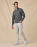 Full-length view of model wearing the Warren Quarter Zip in Black with white pants and white sneakers.