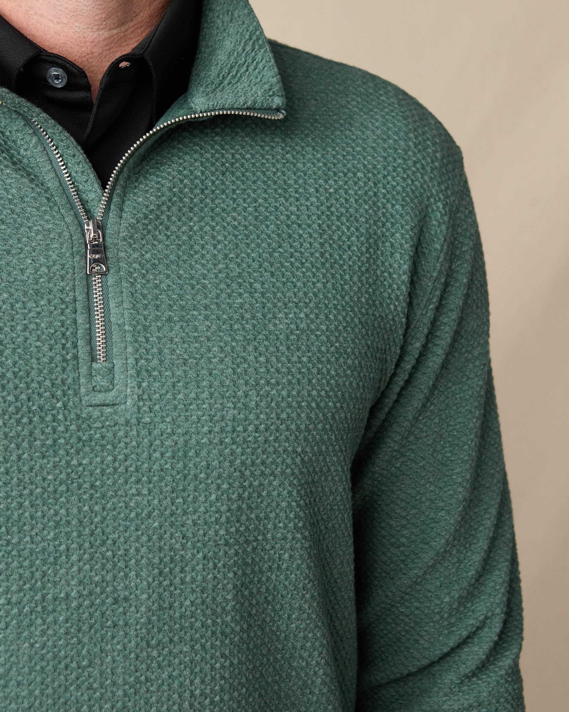 Close-up of the Topanga Quarter Zip in Dark Forest, featuring textured knit fabric, a metal quarter-zip closure, and stand collar.