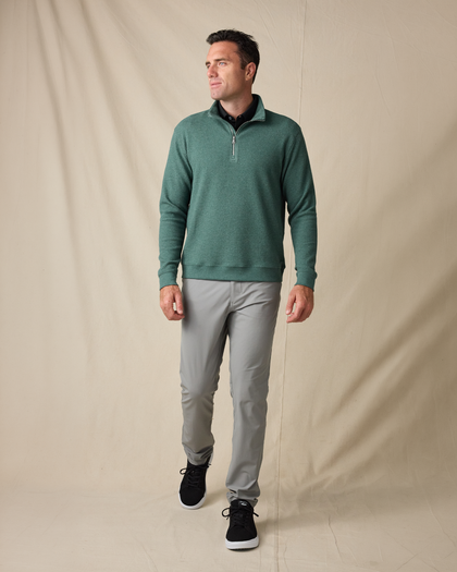 Model wearing the Topanga Quarter Zip in Dark Forest with gray pants and black sneakers.