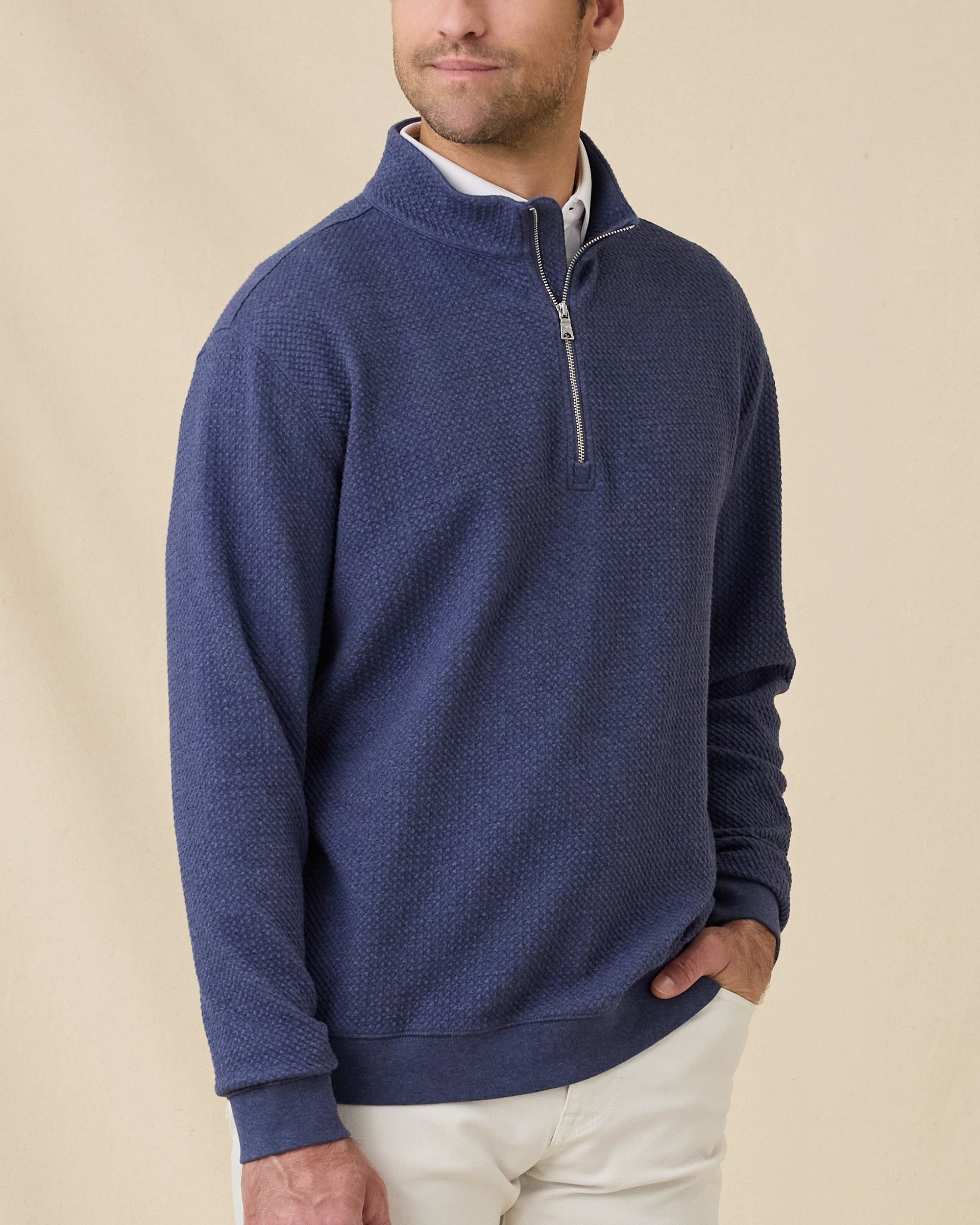 Model wearing the Topanga Quarter Zip in New Indigo layered over a white polo