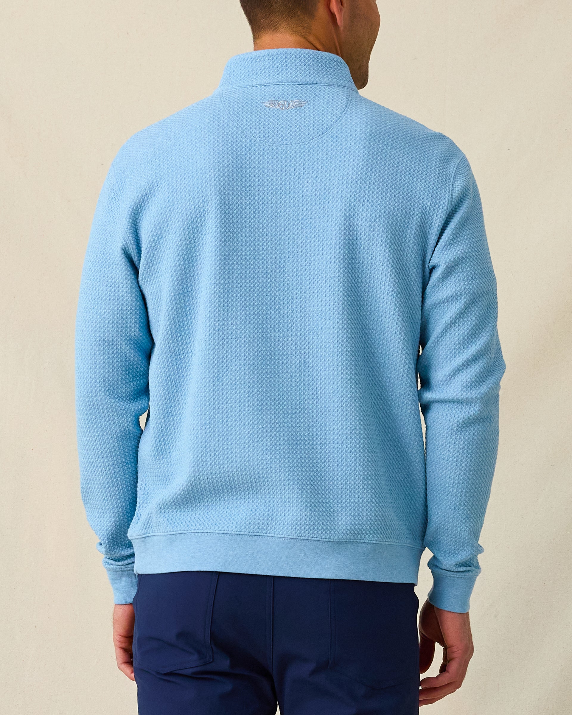 Men's Topanga Quarter Zip in Coastal, back model view featuring a medium blue long sleeve quarter zip pullover with an allover raised diamond textured fabric, with an embroidered Straight Down logo at the back collar