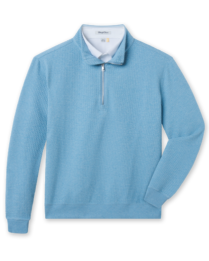 Light blue quarter zip pullover with bubble knit texture layered over white polo