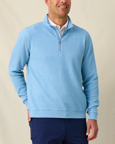 Men's Topanga Quarter Zip in Coastal, front model view featuring a medium blue long sleeve quarter zip pullover with an allover raised diamond textured fabric, layered over a white polo, styled with navy pants