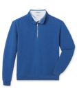 Blue bubble knit quarter zip layered over a white polo