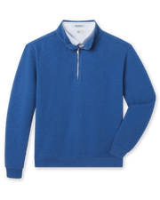 Blue bubble knit quarter zip layered over a white polo