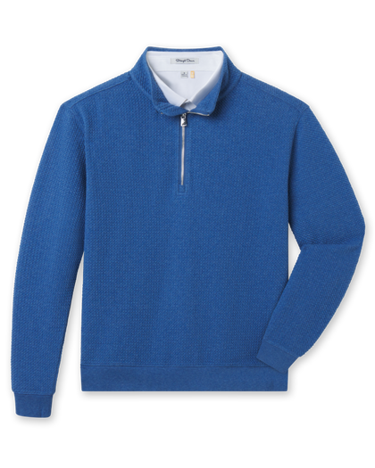 Blue bubble knit quarter zip layered over a white polo