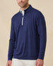 Front view of a male model wearing the Palmer Quarter Zip in New Indigo over a white polo with light-colored pants.