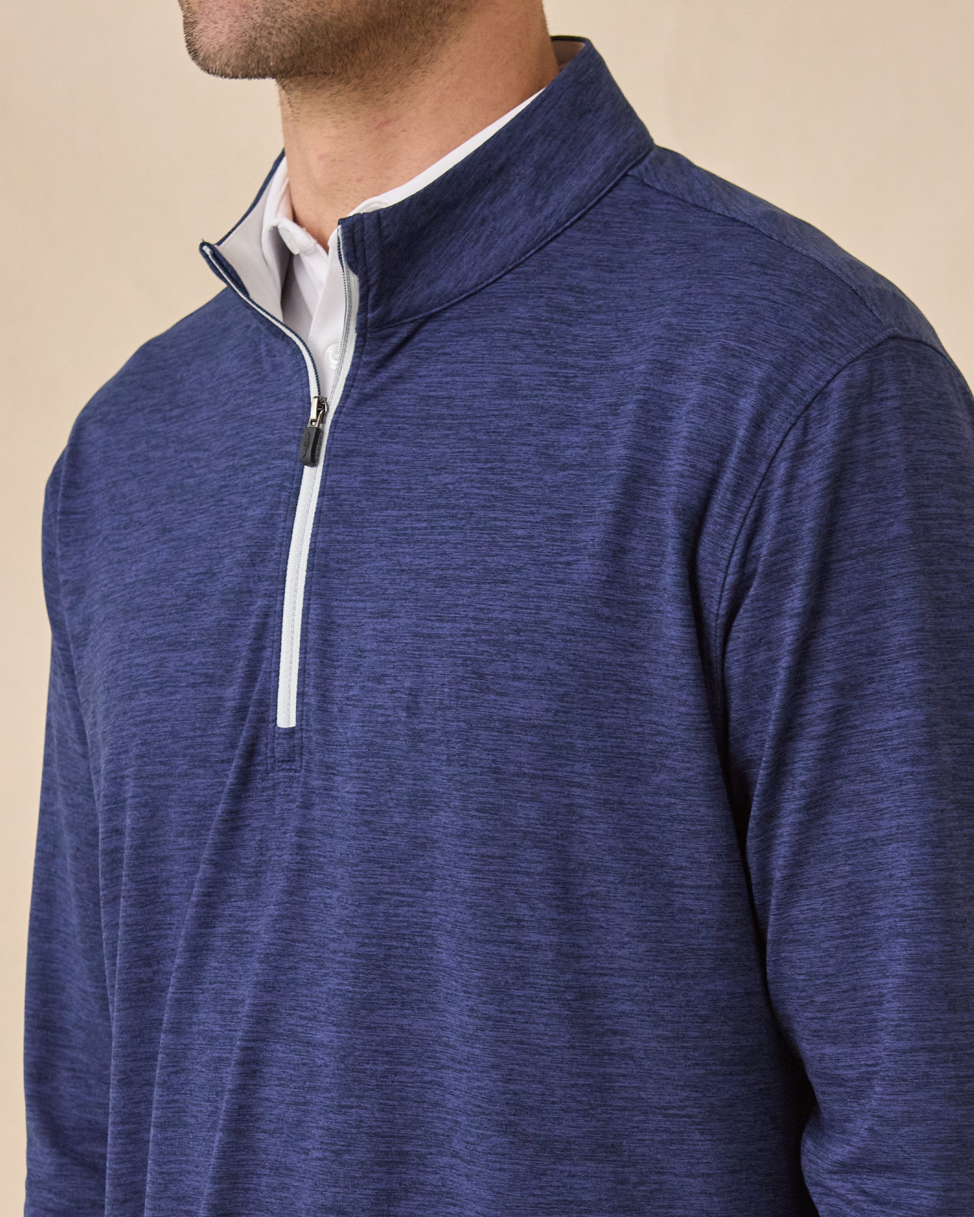 Close-up of the Palmer Quarter Zip in New Indigo, highlighting the heathered fabric, stand collar, and contrast zipper.