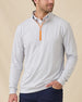Model wearing the Palmer Quarter Zip in Heather over a white polo, showing the light heathered fabric and contrasting orange quarter-zip detail.