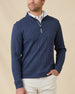 Male model wearing the Huntington Quarter Zip in New Indigo layered over a white polo, showing the textured knit and relaxed quarter-zip collar.
